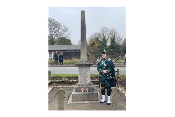 A photo showing the bag piper at the Remembrance parade